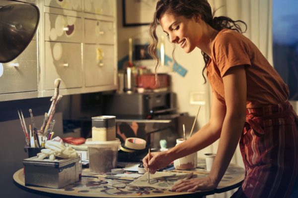 photo of woman painting while smiling and standing by the 3811830 600x400 - Moms Need To Relax Too!